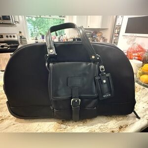 Tumi Black Roller Travel Bag and Matching Tote with Sophisticated Design